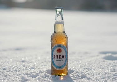 A chilled, condensation-covered bottle of lager on a bright, soft snow white surface, reflecting the purity of its glacial water origin.
