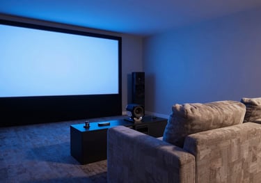 Photography of a sophisticated home cinema setup in a US home, ambient blue lighting, comfortable designer seating, focusing on cutting-edge technology.