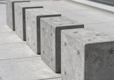 A row of industrial-style gray cement roster blocks with a star pattern, installed in a modern patio, clean lines, minimalist architectural photography.