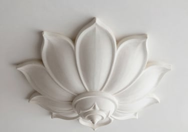 Elegant white gypsum ceiling ornament with a minimalist lotus design, photographed from below against a clean white ceiling, soft studio lighting.