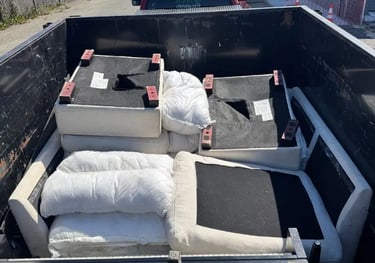 trailer with a sectional couch and pillows in it