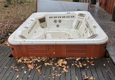 hot tub and cover in a deck