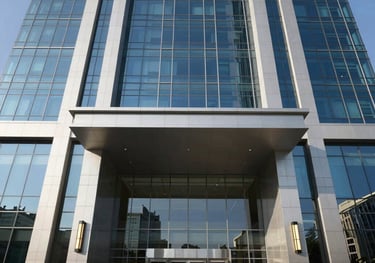 A detailed crisp photograph of an ultra-modern corporate office building entrance in Dubai, reflecting clear blue skies, professional executive architectural style suited for international business.
