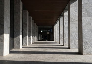 Symmetry and shadows in a modern architectural corridor of a top-tier law firm, conveying structure and precision. Global / High-end corporate.