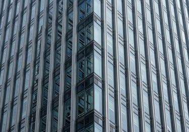 A minimalist, structured view of a glass and steel skyscraper, highlighting clean lines and architectural sophistication. Global / High-end corporate.
