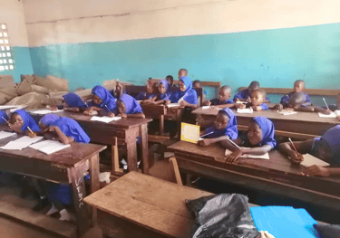 A student teaching in a village school supported by Maakitheena – Sierra Leone education and Islamic