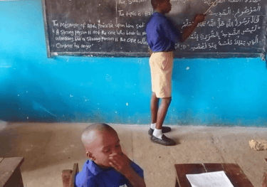 Children learning and teaching Qur’an in a Sierra Leone village school – Maakitheena