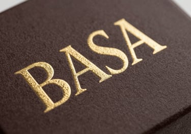 A macro photography shot of luxury packaging with gold embossed lettering on a deep brown paper texture. North American professional branding style, clean and sharp focus.