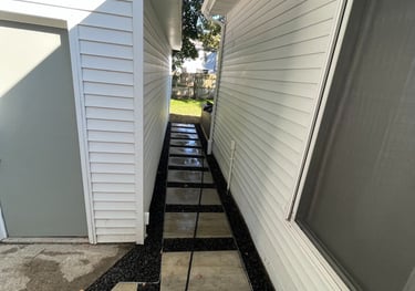 Concrete pavers and black lava rock walkway.