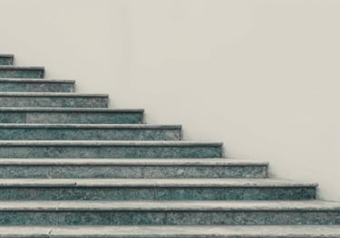 A sequence of stone steps leading upward in a clean, minimalist landscape, representing the gradual power of the PPP methodology. Soft teal and grey tones #A7C2BF.