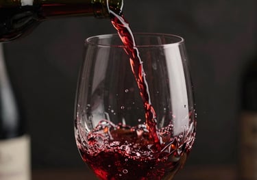 Close up of red wine being poured into a large crystal glass, dynamic splash, dark background with orange light highlights.