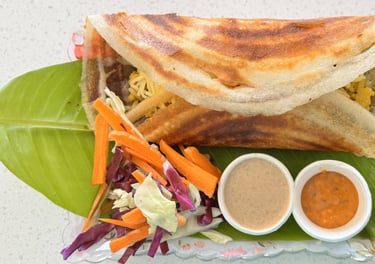 Masala dosa filled with spiced potato, served fresh at Aroha Dosas