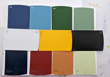A color pallet selection of paint chip samples used to define the color theme of an interior mural.