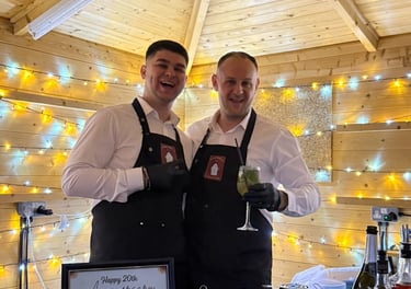 Professional bartenders serving cocktails at mobile bar hire event in London