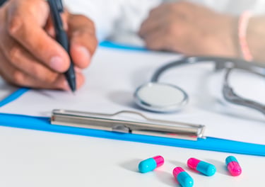 Doctor writing a prescription for patient medication