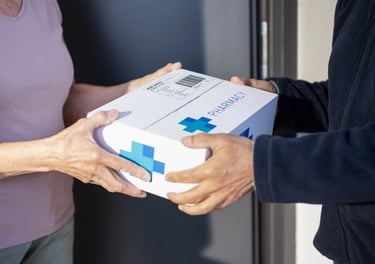 Pharmacy staff delivering prescription medication to a patient