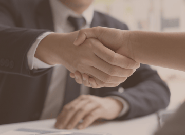 a man and woman shaking hands in a meeting
