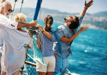 A happy family with arms raised enjoys a summer sailing vacation on a boat at sea.