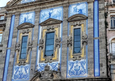 Blue and white mosaic-covered exterior of Igreja Church with three arched windows in Porto, Portugal