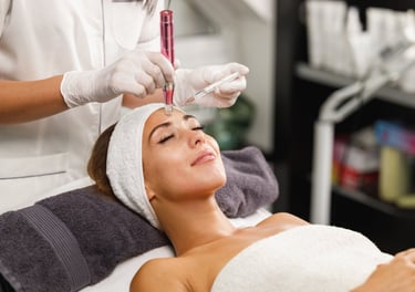 Esthetician performing a PRP treatment to a female client