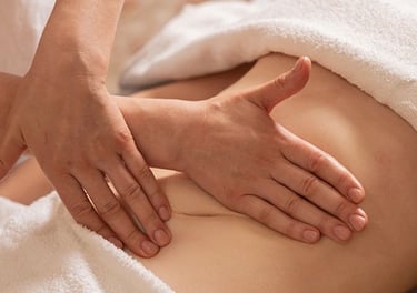 Hands massaging someone's stomach.