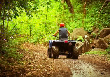 a man riding a four - wheeler atv