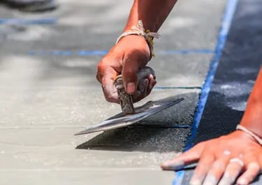 West Linn concrete contractor using trowel to smooth concrete repair