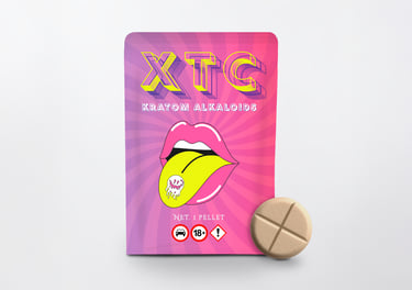 Pink XTC kratom alkaloids pellet packaging featuring pop art lips and a single tan kratom tablet.