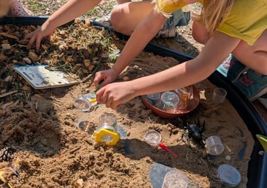 a group of children playing in a sandbox
