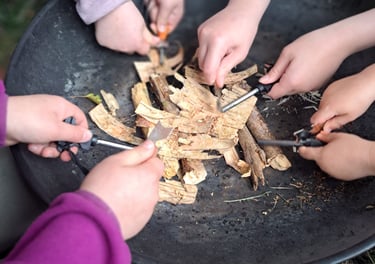 a group of children's hands learning to light fires