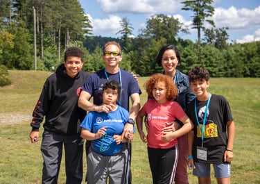 a family posing for a picture in a field