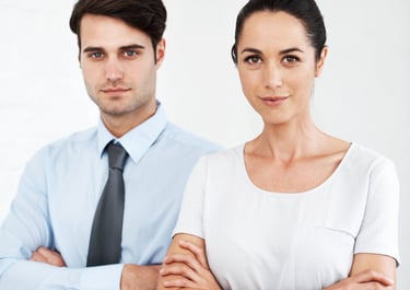 a man and woman standing in front of a white wall