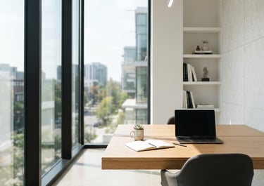 Bright architectural photography of a modern minimalist office workspace, natural sun-drenched daylight, clean lines, 35mm lens