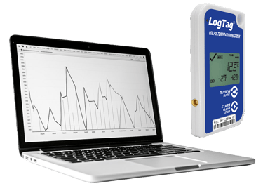 LogTag USB PDF temperature data logger next to a laptop displaying a line graph of recorded thermal data.