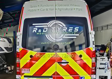 R&D Tyres mobile tyre service van inside a garage for puncture repair and wheel fitting.