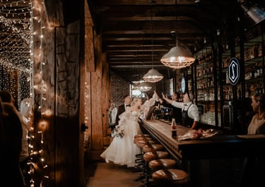 a bride and groomsmen are standing in a bar