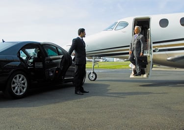 a man in a suit and tie is getting ready to board a private jet