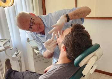 a man in a dentist's chair with a glove on his hand