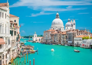 The Grand Canal in Venice featuring the Basilica di Santa Maria della Salute and boats on turquoise water.