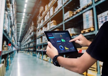 a man in a warehouse with a tablet and a tablet