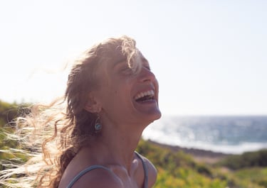 a woman with blonde hair and a blue dress smiling