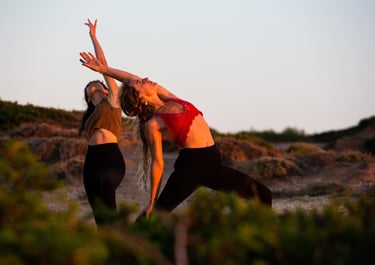 two women doing yoga in nature