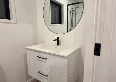 Bathroom vanity with large round mirror