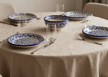 Detail of a luxury dining table setup with traditional Moroccan ceramics in a modern, minimalist style, sand-colored tablecloth.