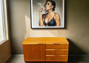 Small McIntosh teak cupboard in Mid Century Modern style with practical storage and timeless vintage appeal.