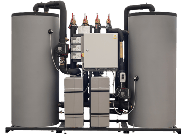 Industrial heat recovery system with twin vertical storage tanks and Grundfos circulation pumps.