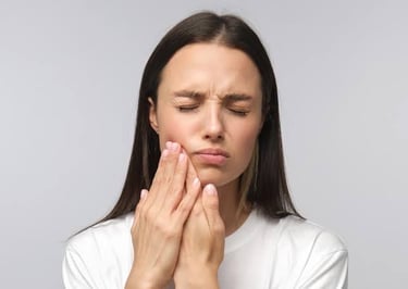 Physiotherapist performing jaw mobilization therapy for TMJ pain relief.