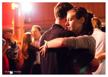 A woman dancing tango with closed eyes.