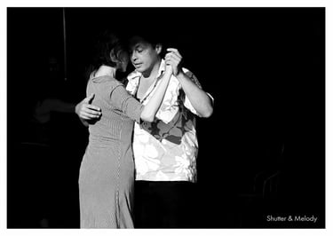 A couple dancing tango, emerging from the shadows at Radial System in Berlin.