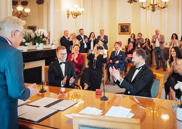 Mariage civil d'un couple à la mairie de Luxembourg entourés de leurs proches applaudissant.